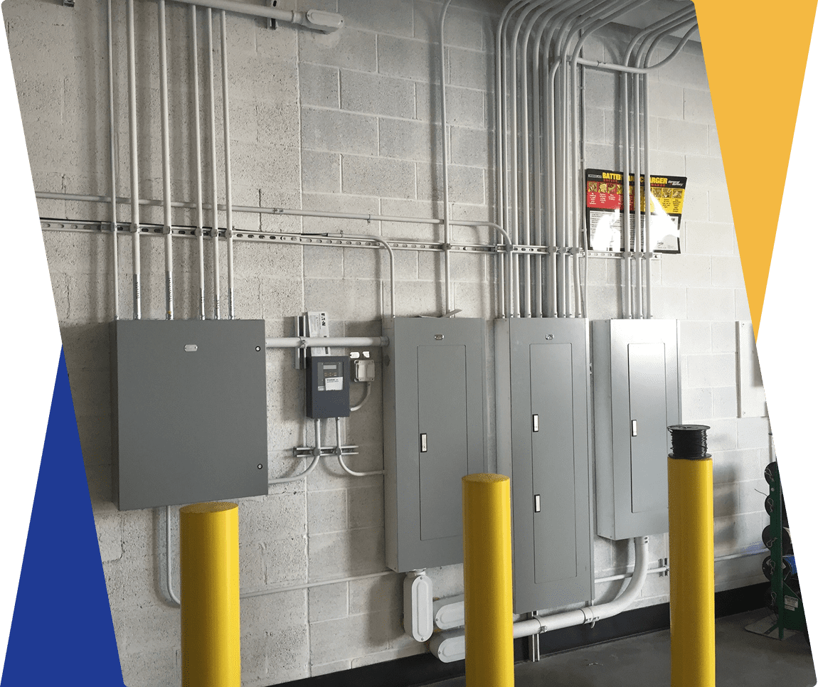 Electrical panels and pipes on industrial wall.