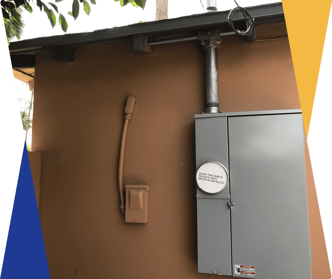 Electrical box mounted on brown wall exterior.
