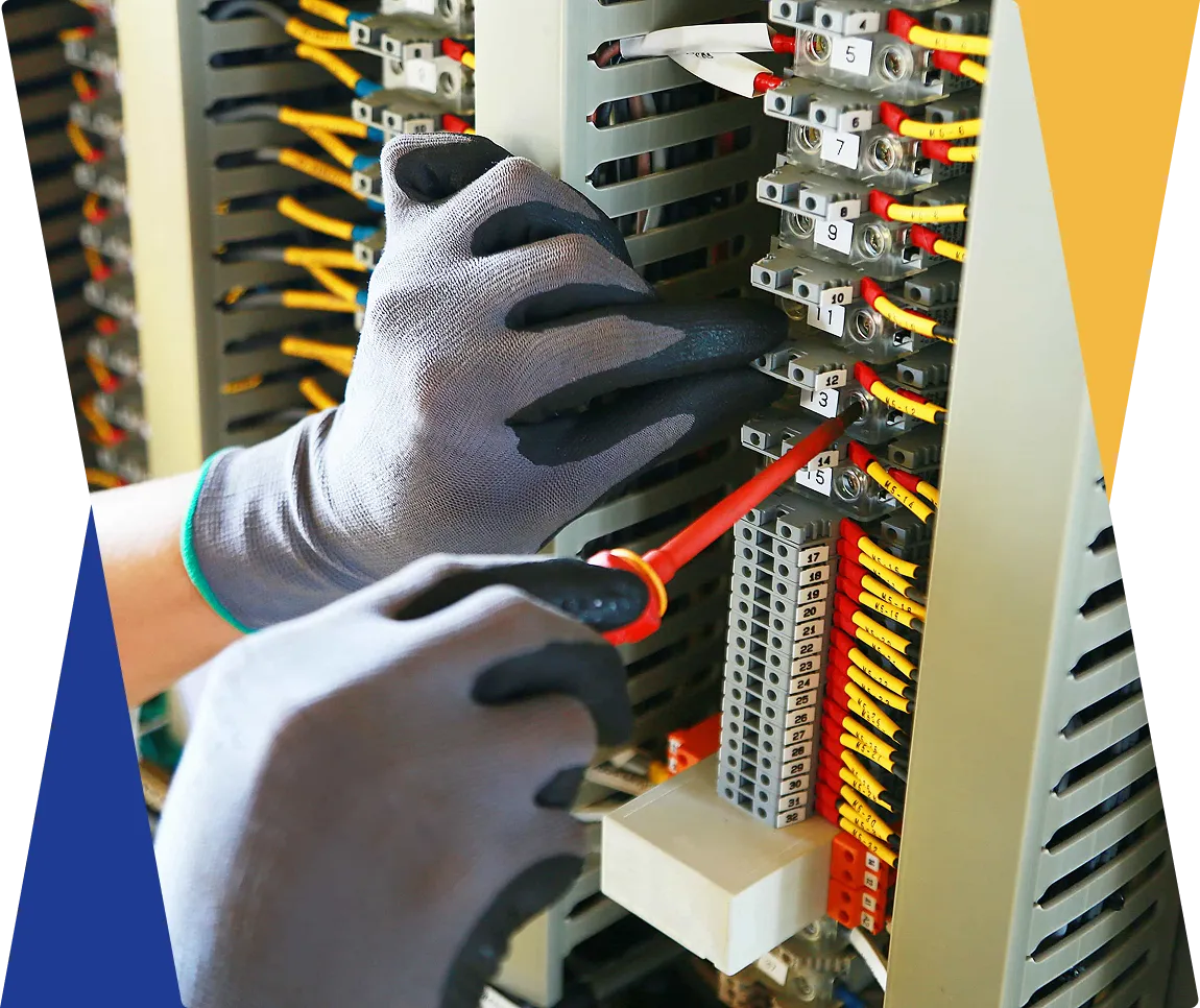Technician working on electrical panel wiring.