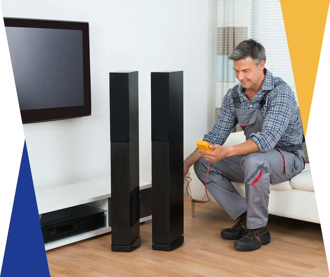 Man testing home speakers with multimeter.